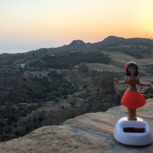 Solar powered dancing doll with mountains in background
