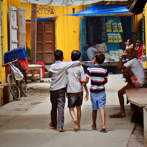 Three children walking down a street