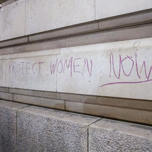 Wall art saying 'Protect women now'