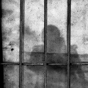 Prison bars with a shadow on the wall